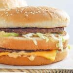 Homemade McDonald's big mac on a wood board.