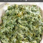 Copycat Boston Market creamed spinach in a ceramic baking dish.
