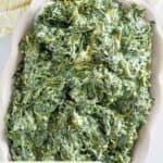 Homemade Boston Market creamed spinach in a rectangular serving dish.