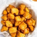 Homemade Chick Fil A chicken nuggets in a parchment paper lined basket.