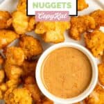 Homemade Chick Fil A chicken nuggets and a bowl of dipping sauce on a plate.