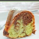 Chocolate pistachio marble cake slice on a plate.