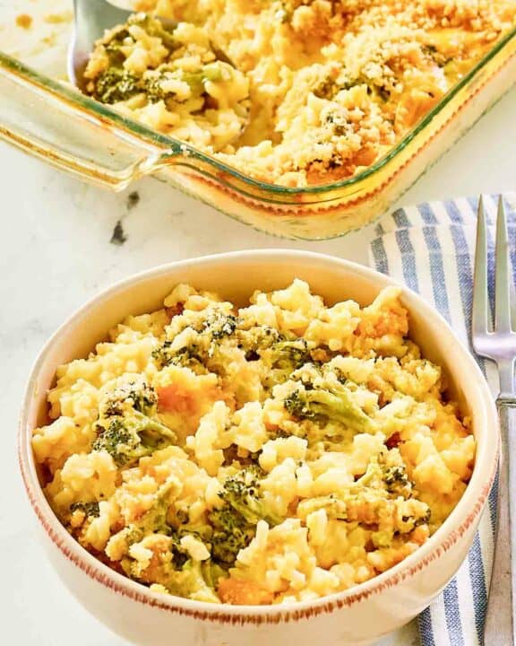 Copycat Cracker Barrel broccoli cheese rice casserole in a bowl and baking dish.
