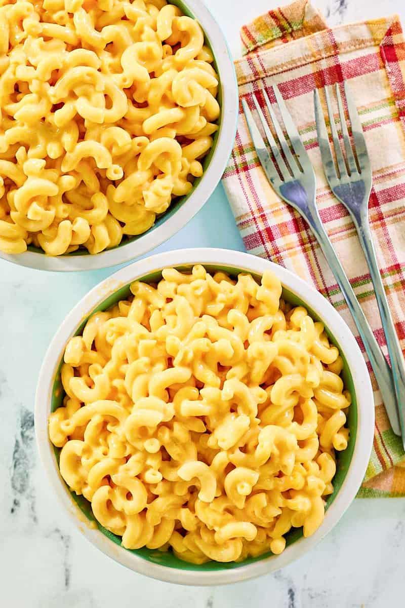 Copycat Cracker Barrel mac and cheese in two bowls and two forks on a napkin.