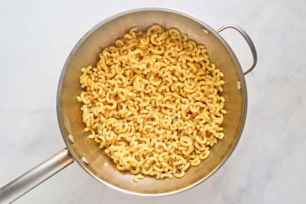 Cooked macaroni in a skillet.