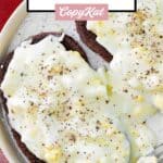 Creamed eggs on toast with black pepper sprinkled on top.