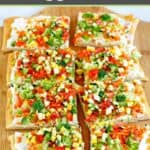 Sliced crescent roll veggie pizza on a pizza peel.