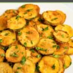 Fried zucchini rounds on a platter.