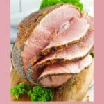 Homemade honey baked ham on a wood board.