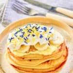 Copycat IHOP minion pancakes and a knife and fork on a napkin.