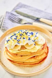 Copycat IHOP minion pancakes and a knife and fork on a napkin.