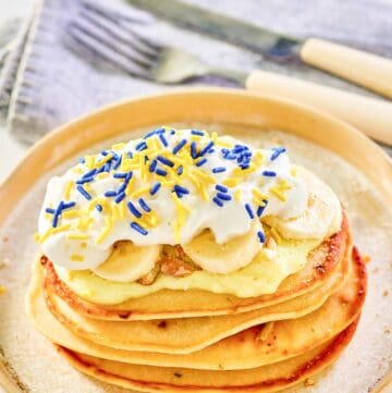Copycat IHOP minion pancakes and a knife and fork on a napkin.