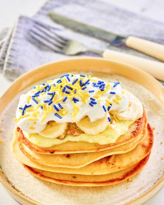 Copycat IHOP minion pancakes and a knife and fork on a napkin.