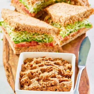 Sandwiches made with homemade Loma Linda sandwich spread and a bowl of the spread.