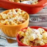 Homemade Longhorn mac and cheese in two bowls and a baking dish.