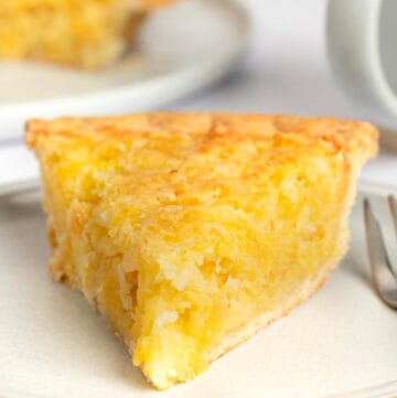 Copycat Luby's Hawaiian pie slice on a plate and the pie behind it.