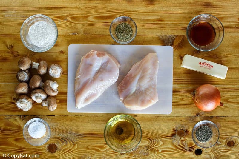 Copycat Olive Garden chicken marsala ingredients on a wood surface.