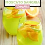 Homemade Olive Garden green apple sangria garnished with orange and apple slices.