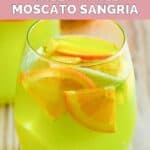 Homemade Olive Garden green apple moscato sangria garnished with apple and orange slices.