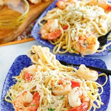 Copycat Olive Garden shrimp alfredo on two plates.