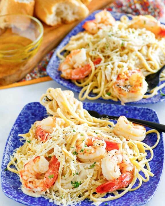 Copycat Olive Garden shrimp alfredo on two plates.
