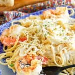 A plate of homemade Olive Garden fettuccine alfredo with shrimp.