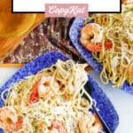 Homemade Olive Garden fettuccine alfredo with shrimp on two plates.
