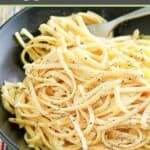 Pasta with egg, parmesan cheese, and garlic in a bowl.