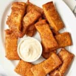 Homemade Pizza Hut cinnamon sticks and a bowl cream cheese frosting for dipping.
