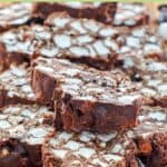 Rocky road candy pieces piled on a wood board.
