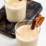 Homemade spiked eggnog in two lowball glasses.