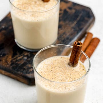 Homemade spiked eggnog in two lowball glasses.