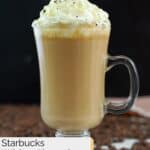 Homemade Starbucks white chocolate mocha and coffee beans scattered around it.