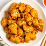 A plate of sweet and sour chicken.