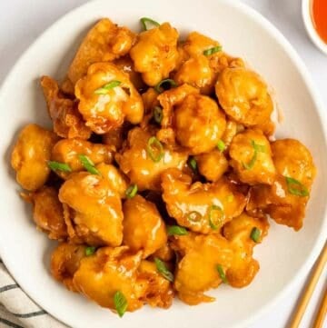 A plate of sweet and sour chicken.