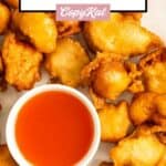 Sweet and sour chicken and toothpicks on a platter.