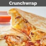 Copycat Taco Bell breakfast crunchwrap on a plate and a small bowl of taco sauce.