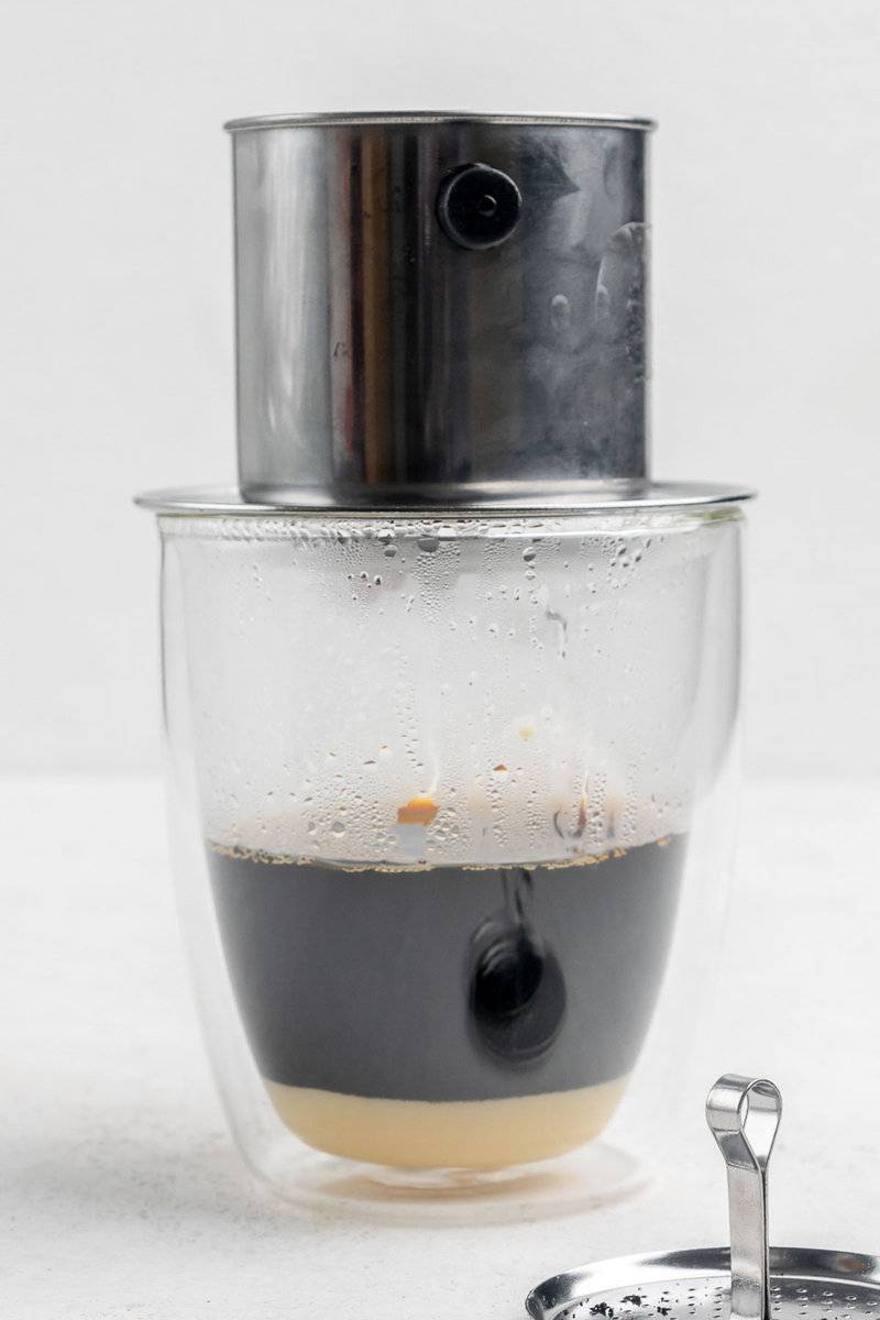 Vietnamese coffee brewing with a phin coffee filter.