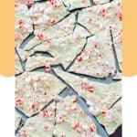 Pieces of homemade peppermint bark on a marble surface.