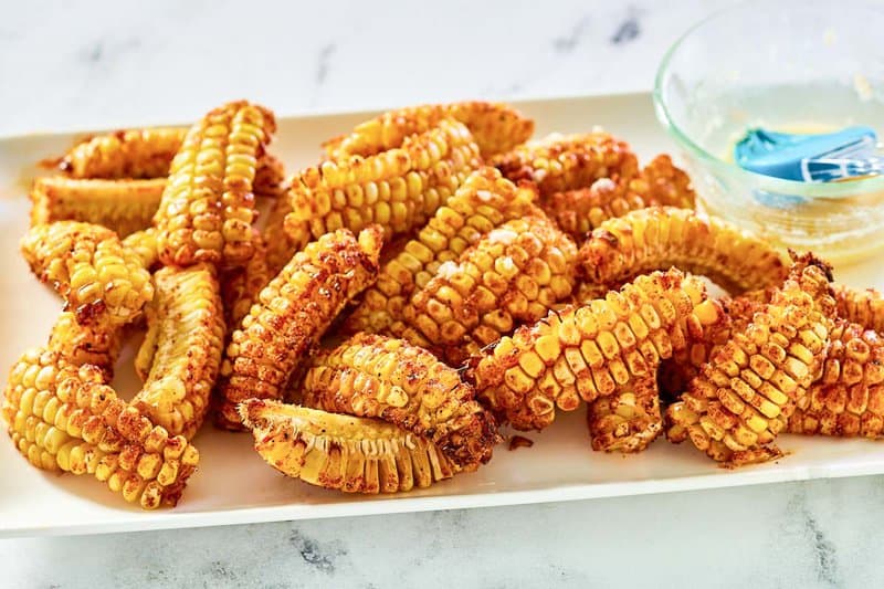 Air fryer corn ribs and garlic butter sauce on a platter.