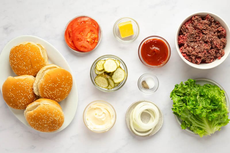 Copycat Burger King Whopper ingredients on a marble surface.