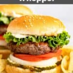 Homemade Burger King Whopper sandwich and potato chips on a plate.