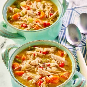 Chicken bisque in two soup crocks.