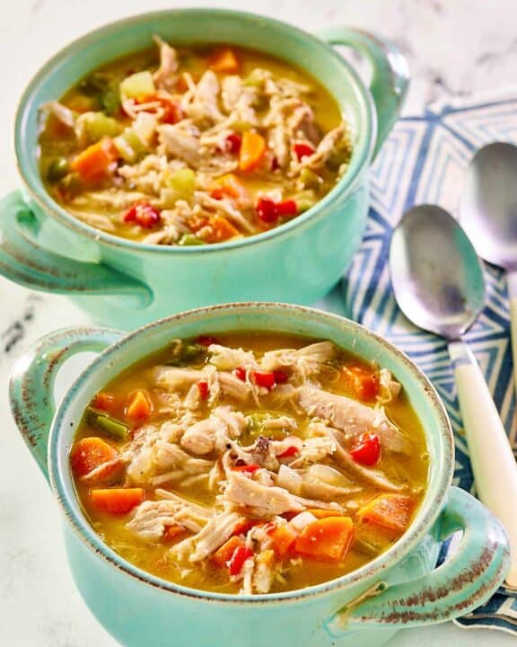 Chicken bisque in two soup crocks.