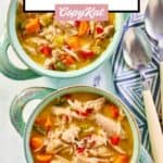 Two bowls of chicken bisque soup and two spoons.