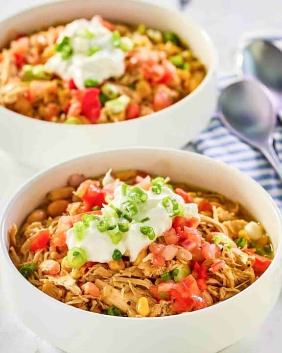 Crockpot white chicken chili in two bowls.