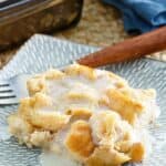A serving of homemade Golden Corral bread pudding with vanilla sauce on a plate.