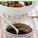 Copycat Hershey's syrup and a spoon in a bowl.