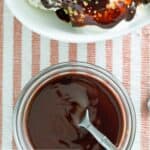 Homemade Hershey's syrup in a small glass bowl and on top of ice cream.