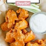 Homemade Hooters wings, dipping sauce, and celery.